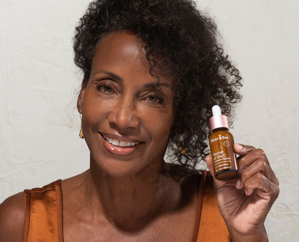 woman holding a vitamin c serum