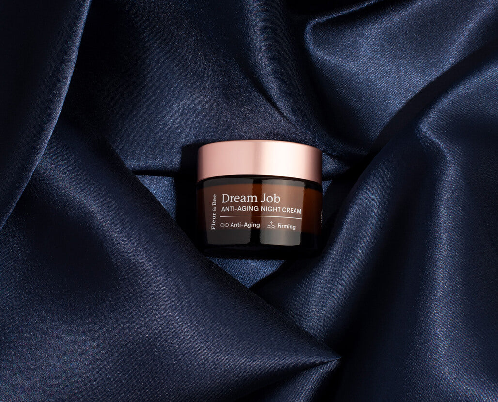 night cream surrounded by blue satin