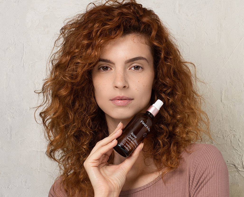 woman holding a vegan rose water toner