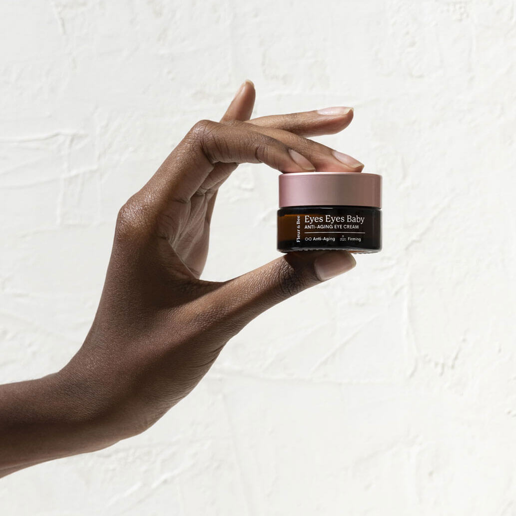 Hand holding an anti-aging eye cream