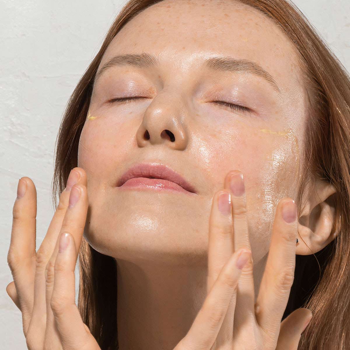 woman experiencing premium retinol serum on her face