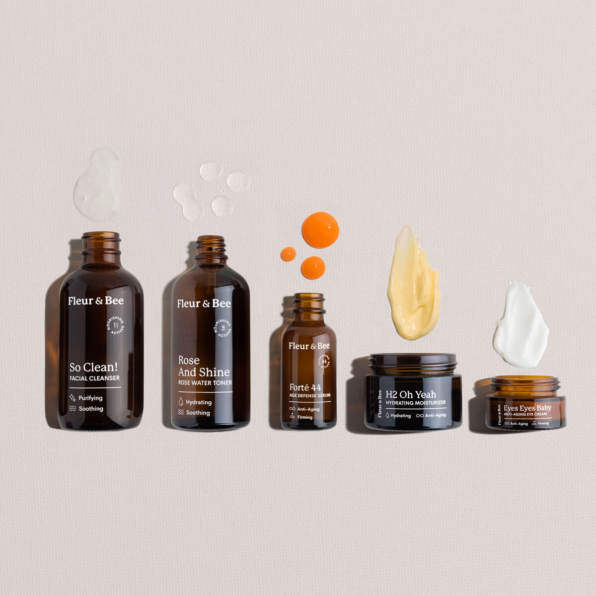 Set of Fleur & Bee skincare products and textures on a neutral background