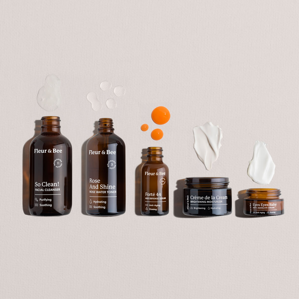 Set of Fleur & Bee skincare products and textures on a neutral background