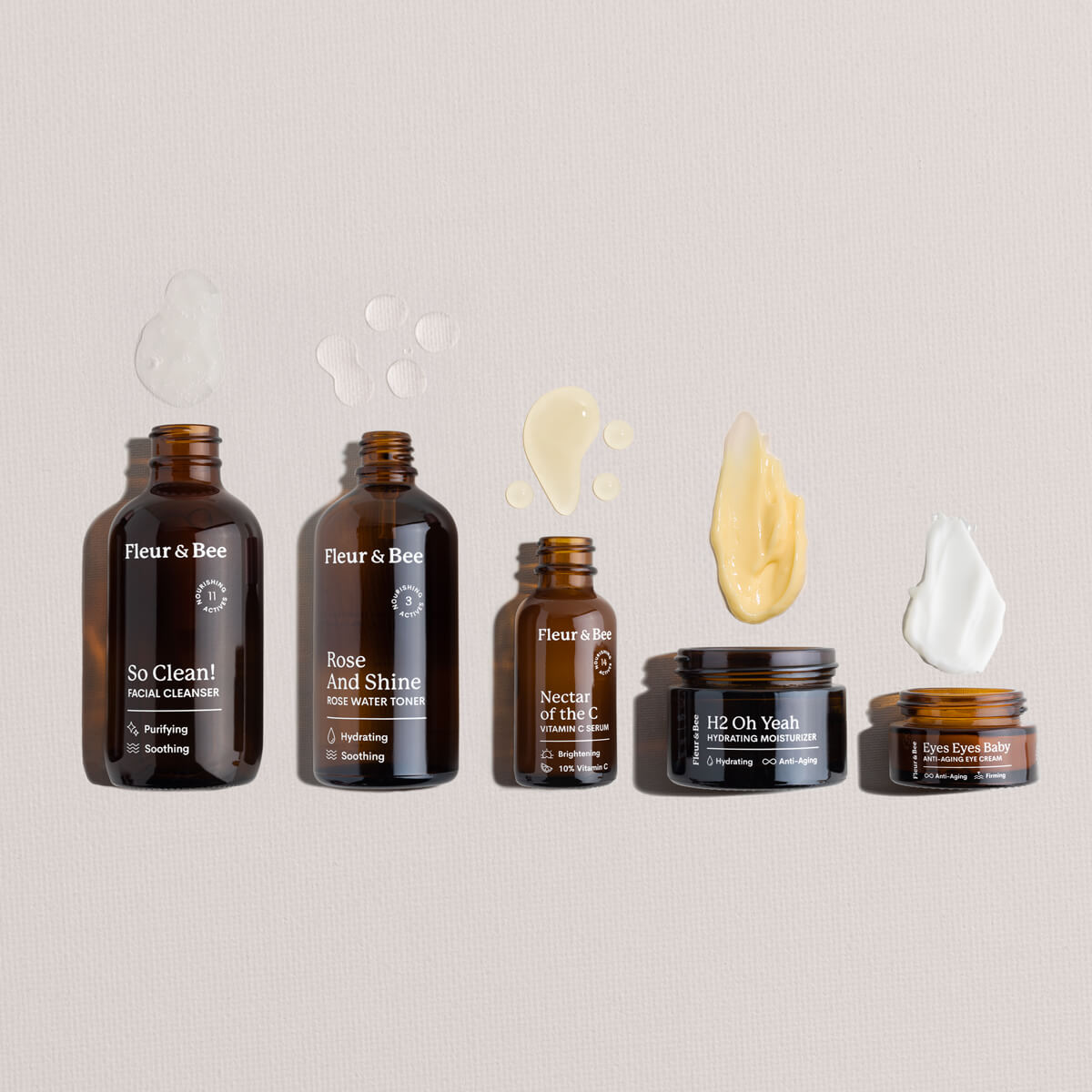Set of Fleur & Bee skincare products and textures on a neutral background
