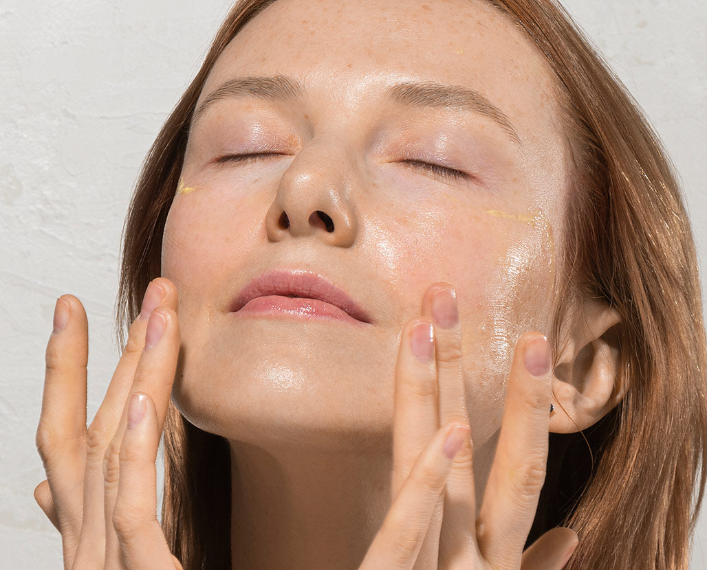 woman experiencing a hydrating serum on her face