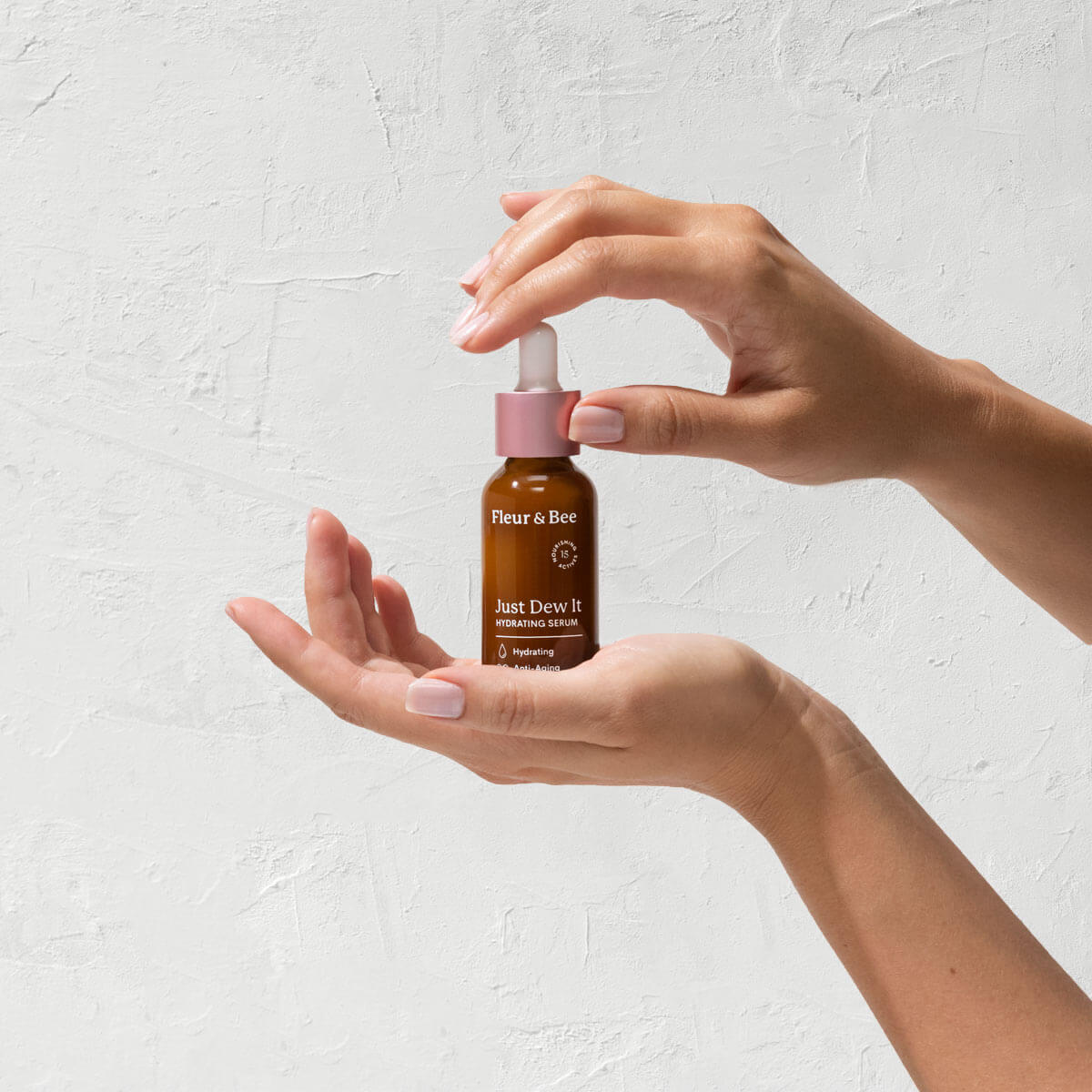 Hand holding and displaying a hydrating serum