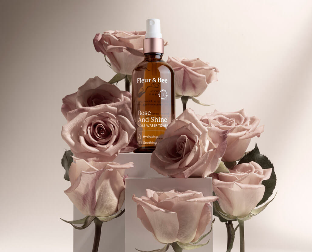 a luxurious rose water toner surrounded by roses