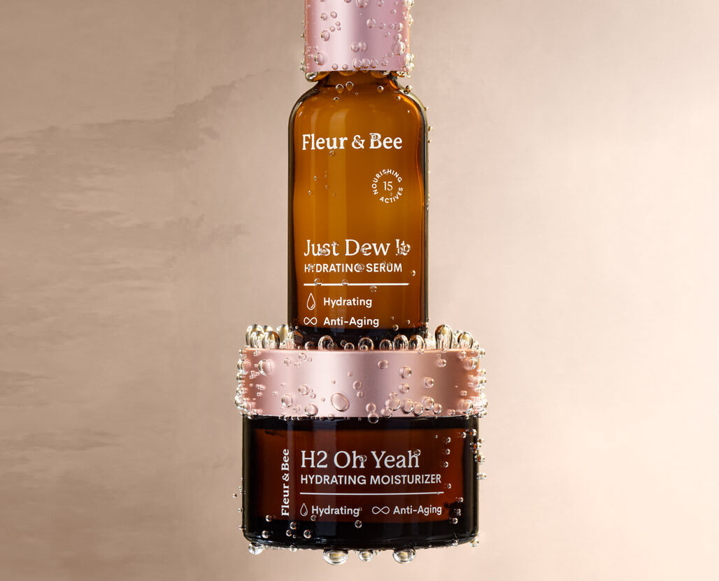 two hydrating skincare products stacked on top of each other in a dewy environment