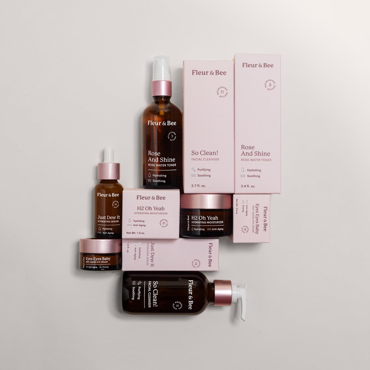 Collection of Fleur & Bee skincare products on a light gray background
