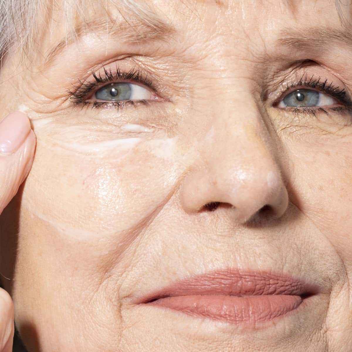 Woman using a face cream moisturizer